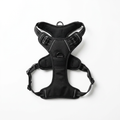 No-pull dog harness laid flat on a white background, showing the front chest ring and the side buckles