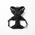 No-pull dog harness laid flat on a white background, showing the front chest ring and the side buckles