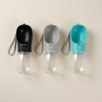 Portable dog water bottles standing side by side in different colours
