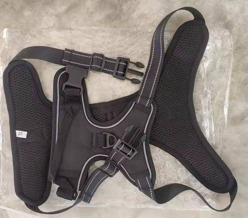 The harness laid flat in size XL, showing the reflective strips, both locking buckles and the top handle