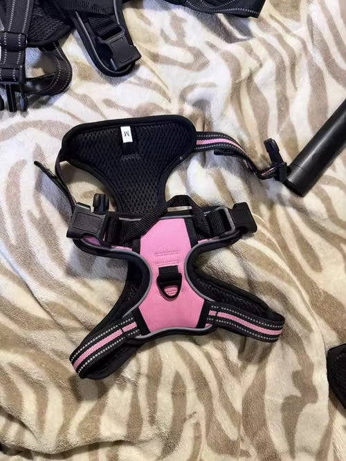The harness in light pink, size M, laid flat with the front ring and size label visible