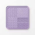 Square silicone dog lick mat on a white background showing its four textured sections