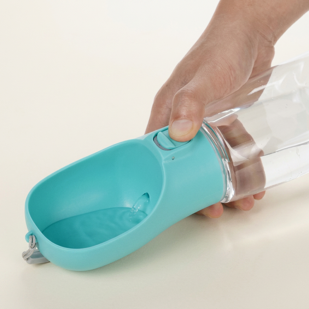 How the dog water bottle works: press and hold to fill the trough, release and the water runs back into the bottle