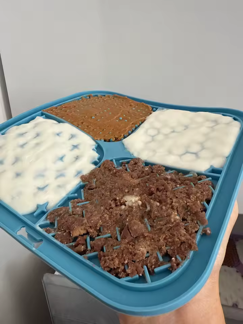 A lick mat spread with four different foods, sent in by an owner