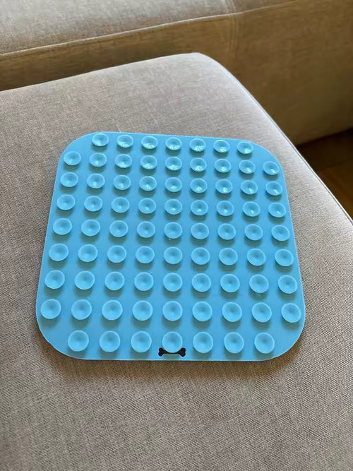 The back of the blue lick mat, showing the full grid of suction cups