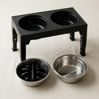 The two thick stainless steel bowls lifted out of the raised feeder frame for washing